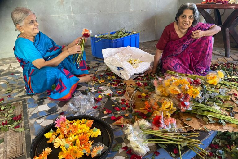 Women farmers or self-help groups sorting or drying flowers.